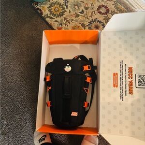 Little Chonk Black and Orange book bag with 2 waterproof bags
